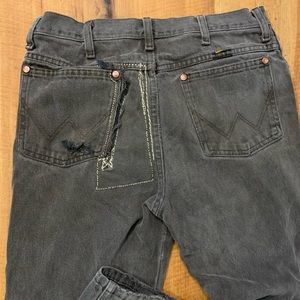 Distressed destroyed workwear wrangler jeans